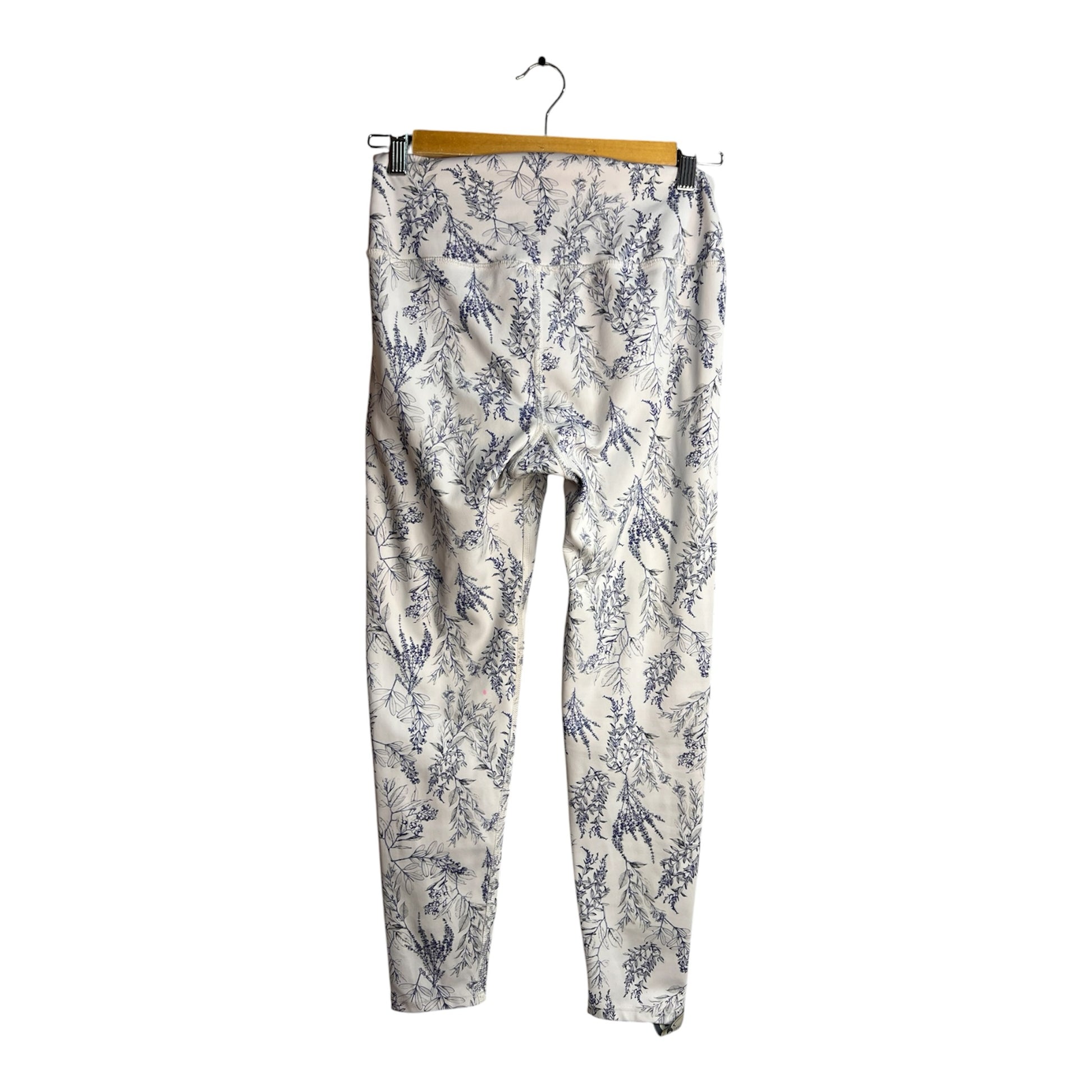 Calzas La Pichilemina de tiro alto con estampado botánico azul sobre fondo claro, ideales para yoga y entrenamiento.