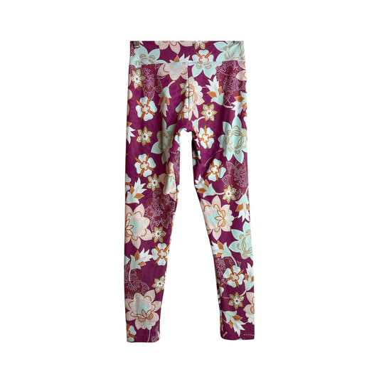 Calzas deportivas La Pichilemina de tiro alto con estampado floral en tonos burdeos, menta y naranja.