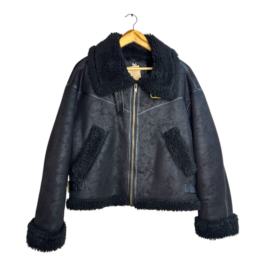 Chaqueta aviador La Pichilemina negra de cuero sintético con forro de chiporro, cuello y puños de peluche suave.